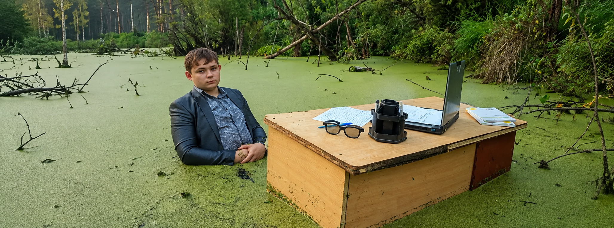 Binance CEO at his desk in the swamp